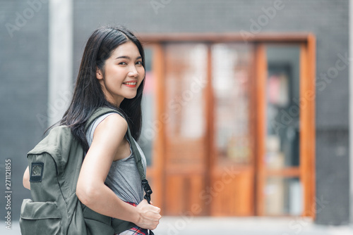 Traveler Asian woman traveling and walking in Beijing, China, backpacker female feeling happy spending relax time in holiday trip. Lifestyle women travel in Asia city concept.