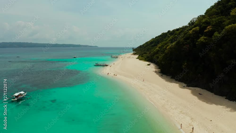 Tropical white sand beach, near the blue lagoon and corall reef from above, Boracay, Philippines. Sandy beach with tourists. Summer and travel vacation concept. Tropical white sand beach, near the blue lagoon and corall reef from above, Boracay, Philippines. Sandy beach with tourists. Summer and travel vacation concept.