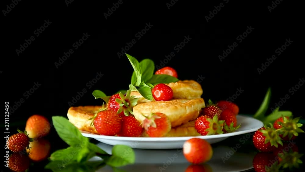 fried sweet pancakes with ripe strawberries in a plate fried sweet pancakes with ripe strawberries in a plate