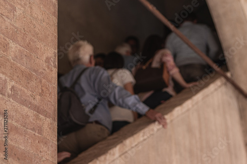 tourists visiting a historical building, going up the stairs