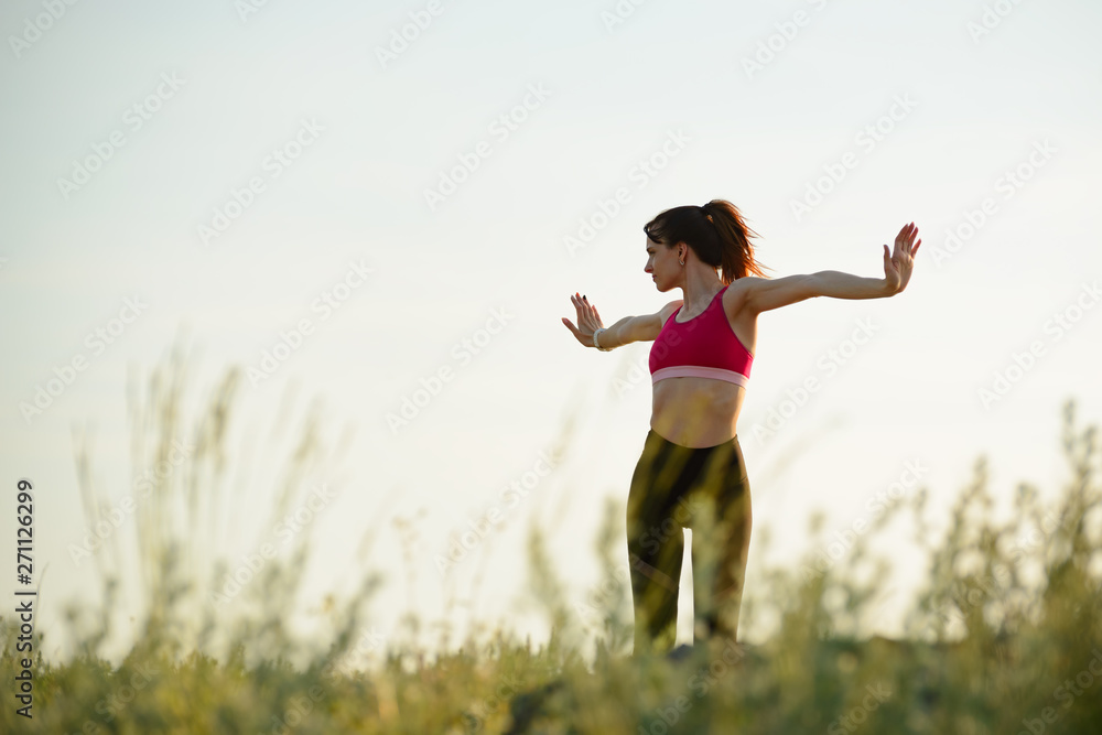 Woman Doing Stretching Outdoor. Warm up Exercise in the Summer Evening. Sport and Healthy Active Lifesyle Concept.