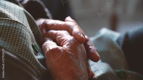 Retired old woman on a nursery home with shiver hands a¡covered with wrinkles. Take care of the elderly in the last phase of their life. Diseases like parkinson are treatable. 