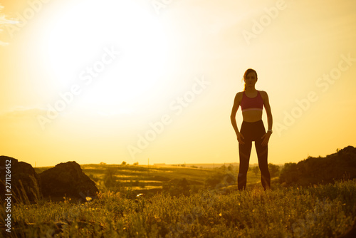 Woman Doing Stretching Outdoor. Warm up Exercise Against Sunset. Sport and Healthy Active Lifesyle Concept.