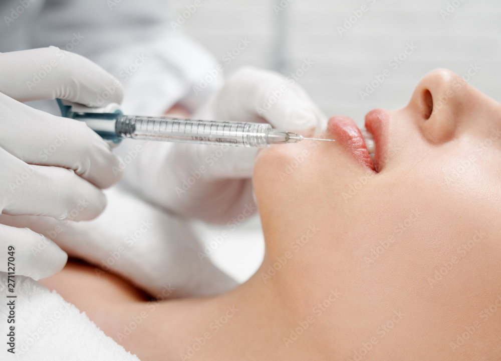 Woman receiving botox in lips for correction and beauty. Woman receiving botox in lips for correction and beauty.
