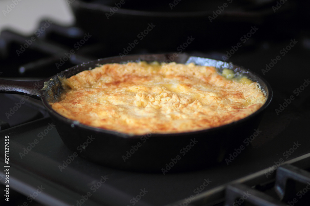 Peach cobbler in a cast iron skillet fresh out of the oven. Peach cobbler in a cast iron skillet fresh out of the oven.
