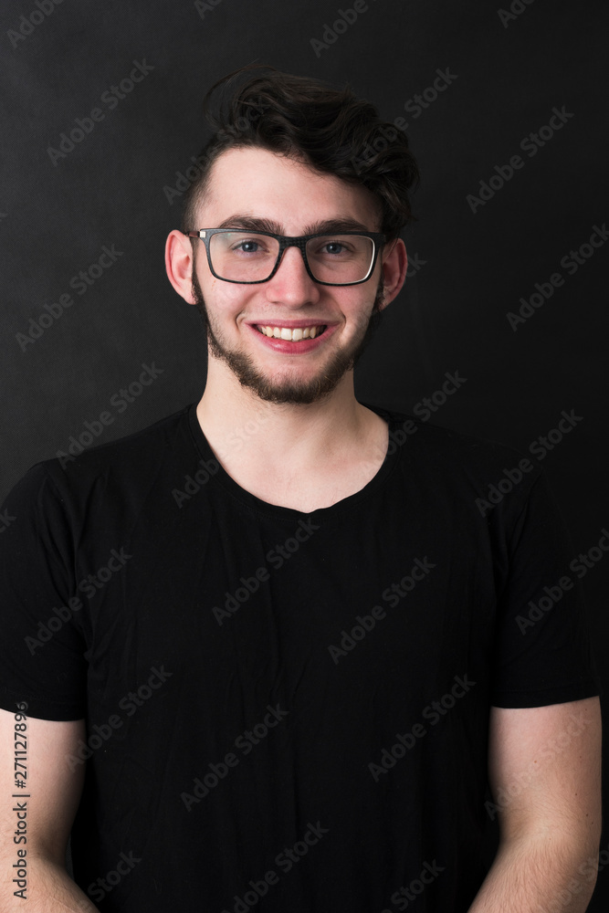 Fototapeta premium Studio shot of young handsome casual businessman against the black background.