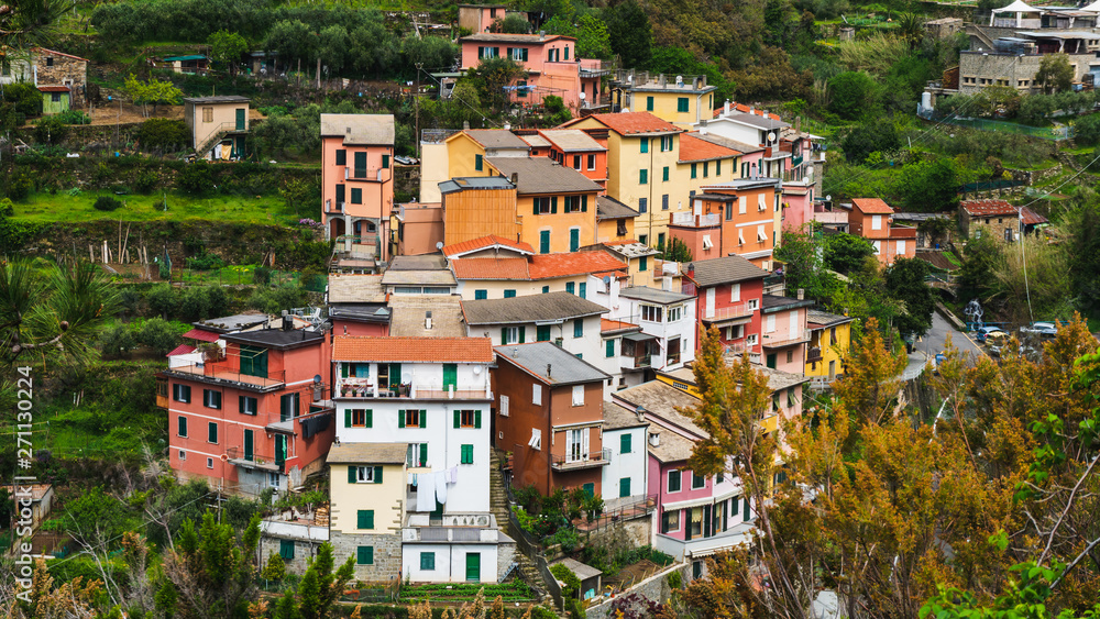 Colorful old traditional Italian houses surrounded by green hills. The little idyllic village of Groppo in Cinque Terre, Italy.