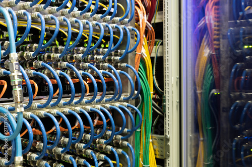 Close-up of modern supercomputer equipment with optic cables and hubs in server room, copy space