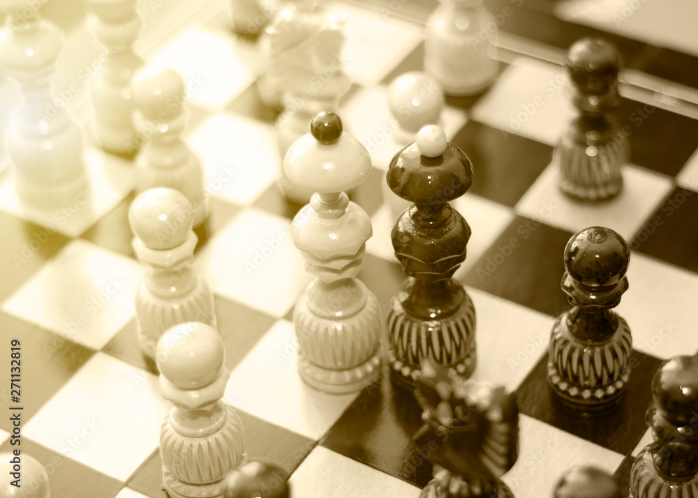 Two chess pieces of the Queen on a wooden Board, surrounded by other chess pieces. The concept of same-sex love, equality and the conclusion of a truce, Union. Black and white retro photo Two chess pieces of the Queen on a wooden Board, surrounded by other chess pieces. The concept of same-sex love, equality and the conclusion of a truce, Union. Black and white retro photo