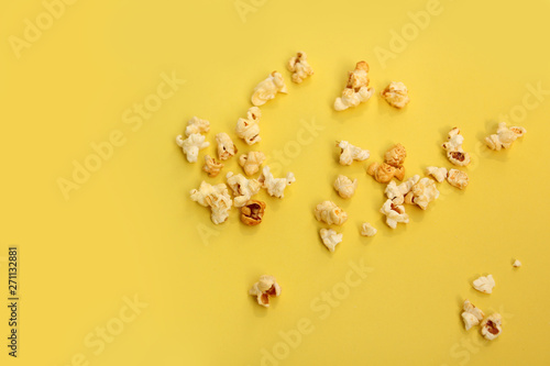 fragrant popcorn scattered on a yellow background, copy space