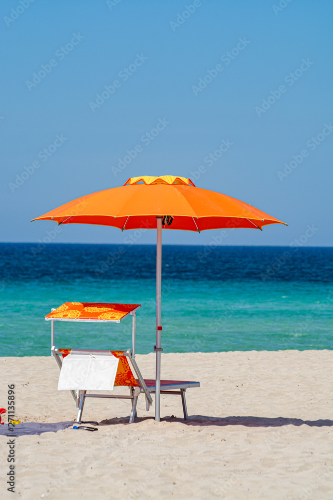 Service on beach, colorful sun bed and parasol for rent on beautiful white sandy beach with crystal clear blue sea water