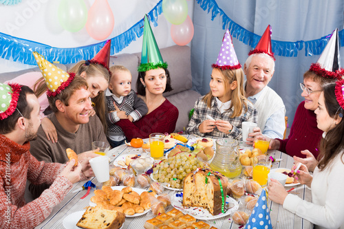 family celebrating children’s birthday during festive dinner