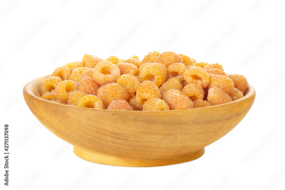 heap of yellow raspberries in wooden plate isolated on white background heap of yellow raspberries in wooden plate isolated on white background