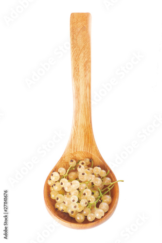 heap of fresh white currants in wooden spoon isolated on white