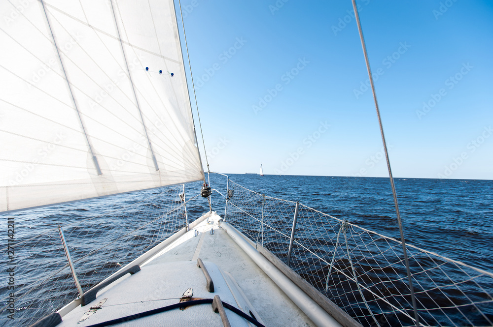 White sailing yacht at a speed swims to shore White sailing yacht at a speed swims to shore