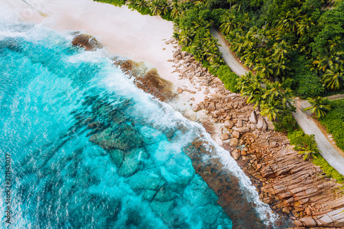 Aerial photo of ocean waves hitting rocky coastline of beautiful paradise dream tropical beach at Seychelles. Summer vacation, travel and lifestyle concept © Igor Tichonow