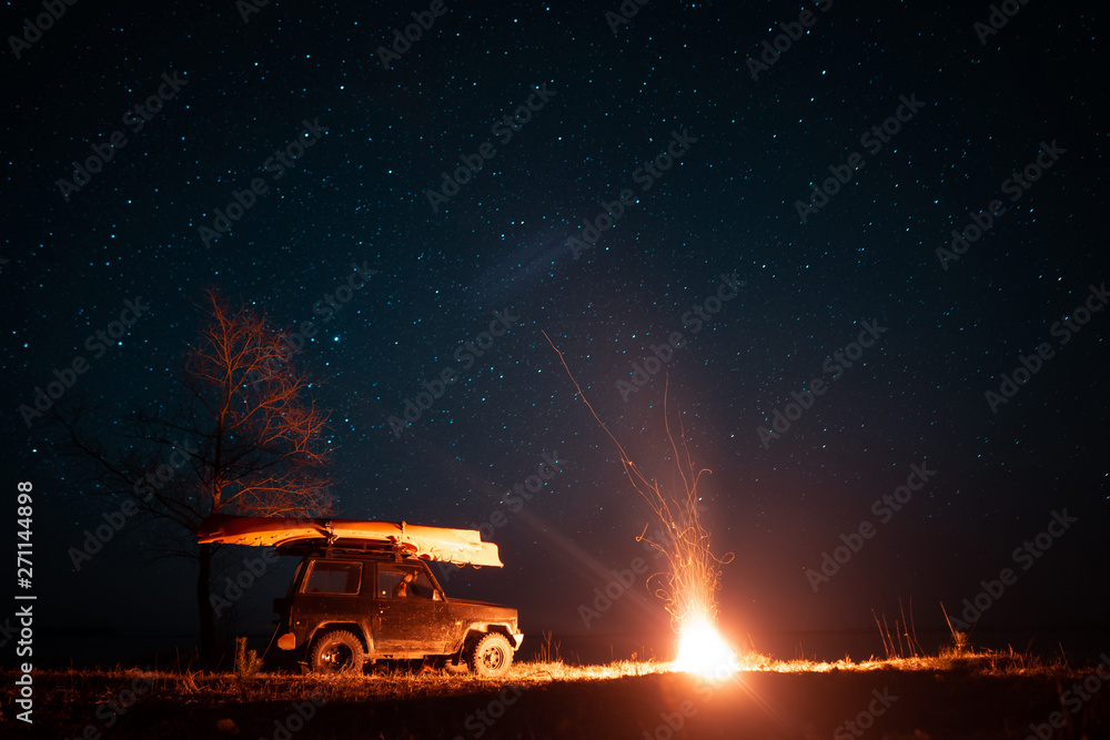 Night landscape with bright campfire and car Night landscape with bright campfire and car