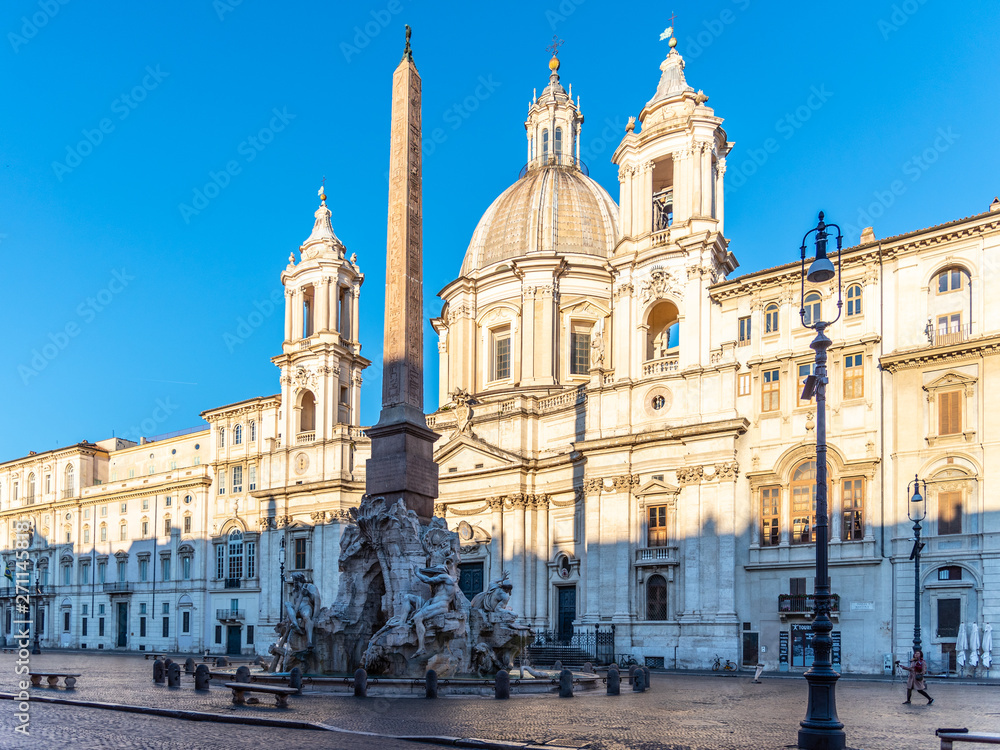Four Rivers Fountain, Italian Fontana dei Quattro Fiumi, with obelisk and St Agnes Church on background. Piazza Navona square, Rome, Italy
