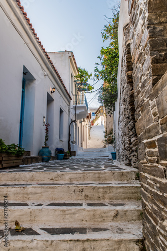 Traditional alley in Batsi village of Andros, on a sunny day, Cyclades, Greece