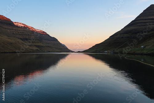 Fjord during sunset with rocky shores © Uladzimir