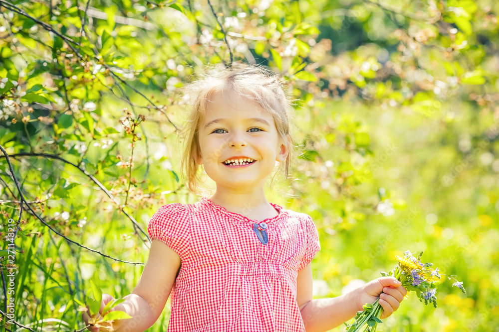 Happy little girl playing with bouquet in sunny park Happy little girl playing with bouquet in sunny park