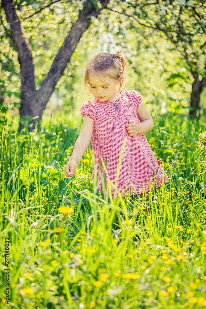 Happy little girl playing in sunny spring garden Happy little girl playing in sunny spring garden