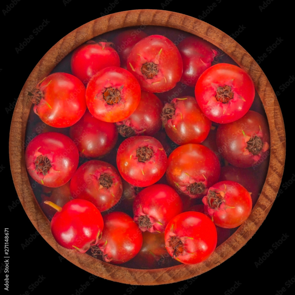 heap of haw in wooden cup isolated on black background. top view heap of haw in wooden cup isolated on black background. top view