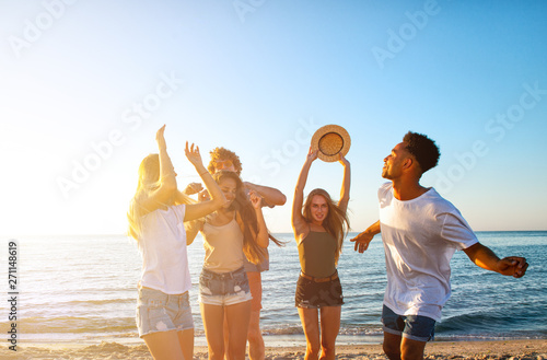 Group of friends dancing on the beach