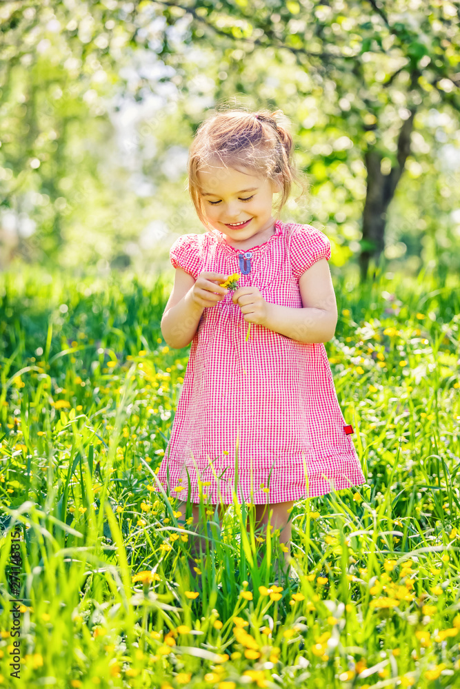 Happy little girl playing in sunny spring garden Happy little girl playing in sunny spring garden