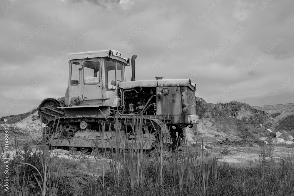 Black and white photo of old, rusty, tracked, diesel, bulldozer.
