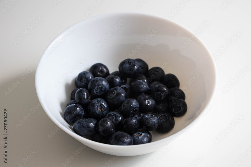Juicy blackberries in a white bowl, berries in a white plate on a white background Juicy blackberries in a white bowl, berries in a white plate on a white background