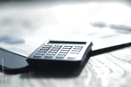 close up. calculator and mobile phone on blurred background