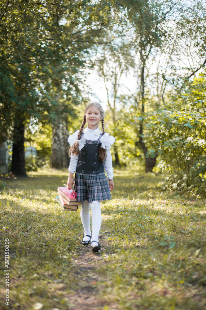 Little pretty schoolgirl with the books on the street Little pretty schoolgirl with the books on the street