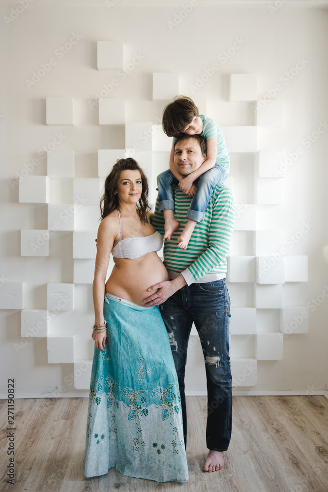 Happy family waiting for a second child. Last months of pregnancy. Pregnant woman with husband and little boy . Second pregnancy, maternity concept. Happy family waiting for a second child. Last months of pregnancy. Pregnant woman with husband and little boy . Second pregnancy, maternity concept.