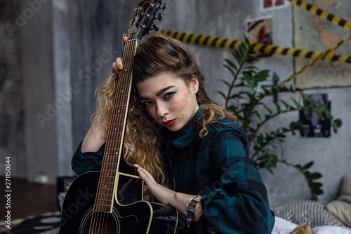 The girl is posing in grunge studio, © selenit