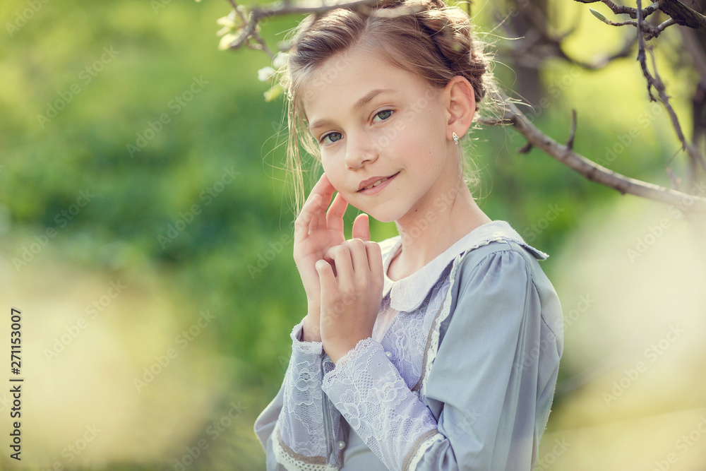 Fototapeta premium Beautiful cute girls in the garden, enjoying the arrival of spring, dresses in vintage style
