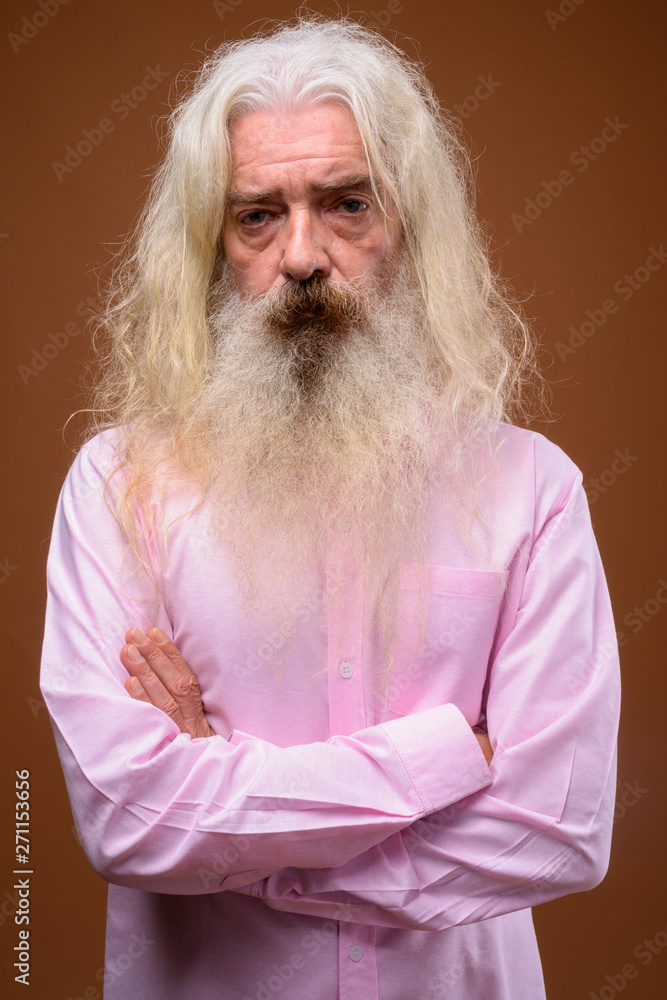 Portrait of senior bearded man wearing pink shirt Portrait of senior bearded man wearing pink shirt