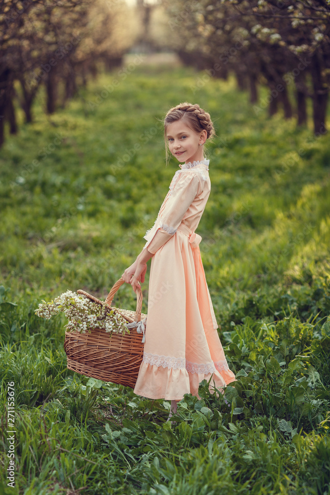 Beautiful cute girls in the garden, enjoying the arrival of spring, dresses in vintage style