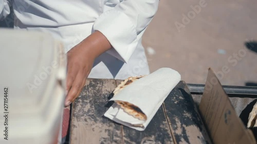 Typical Argentinian food being cooked, prepared and handed to a client. photo