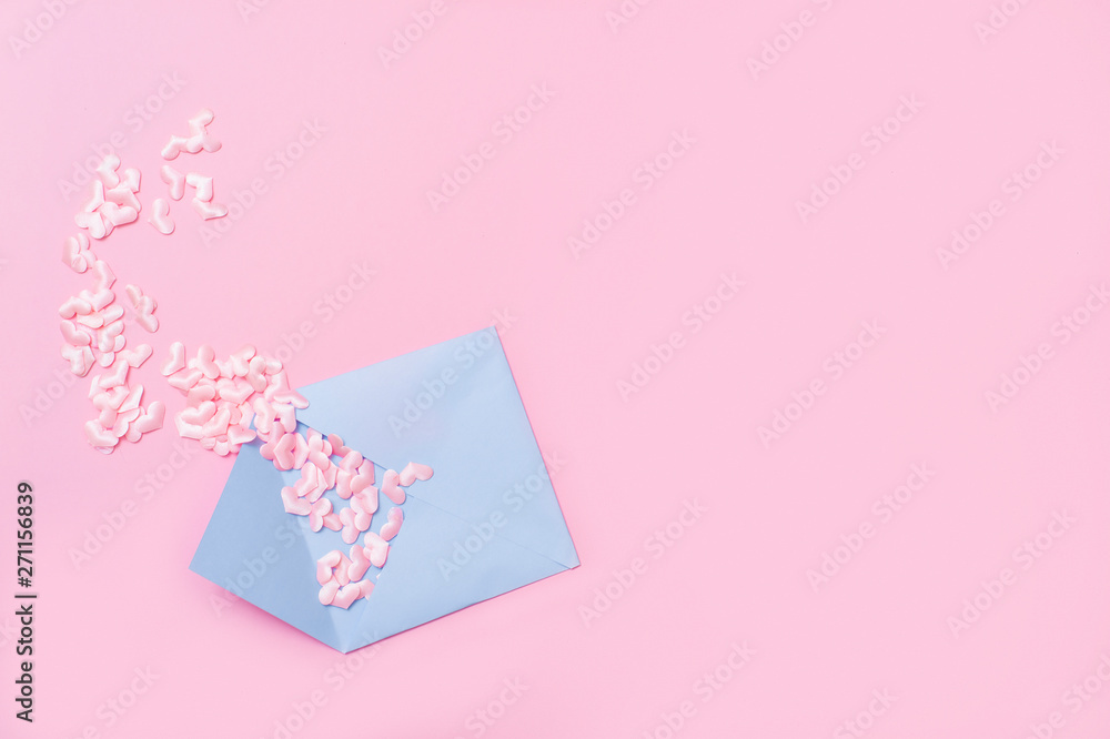 Small pink hearts with envelope, on pink background with copy space