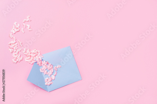 Small pink hearts with envelope, on pink background with copy space © Augustas Cetkauskas
