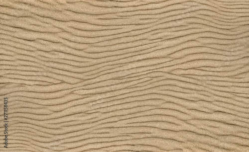 Sand ripple texture. Sandy background. Sand close-up.