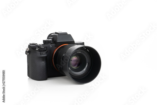 Mirrorless digital camera on pure white background with lens attached