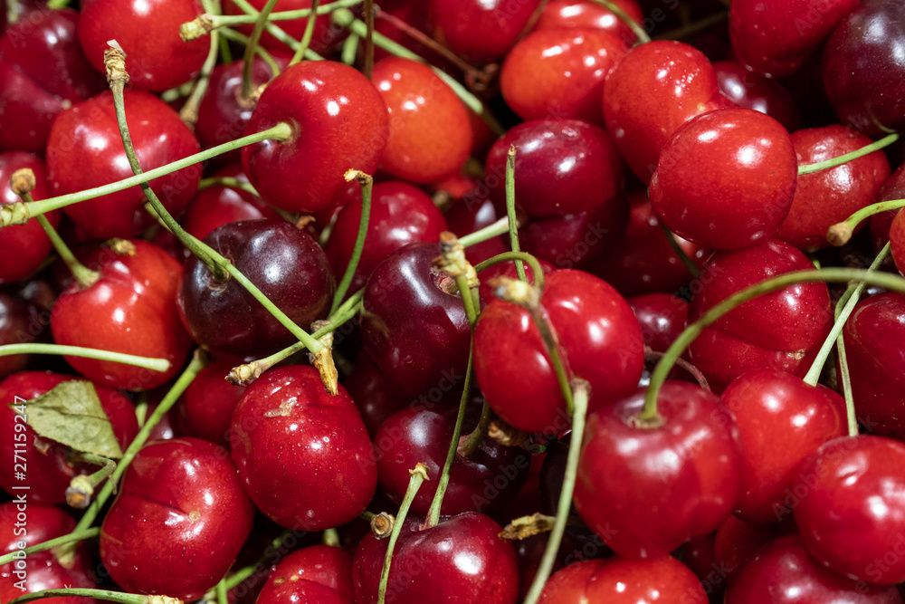 a lot of cherries scattered on the table, ripe cherries a lot of cherries scattered on the table, ripe cherries