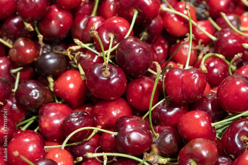 a lot of cherries scattered on the table, ripe cherries a lot of cherries scattered on the table, ripe cherries