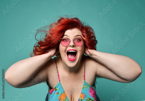 Shouting laughing loud overweight fat woman holds her head with hands can't believe huge discount sale or crazy luck