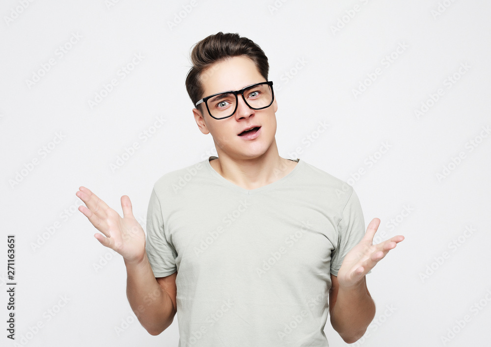 lifestyle, emotion and people concept - portrait of a young man surprised face expression lifestyle, emotion and people concept - portrait of a young man surprised face expression