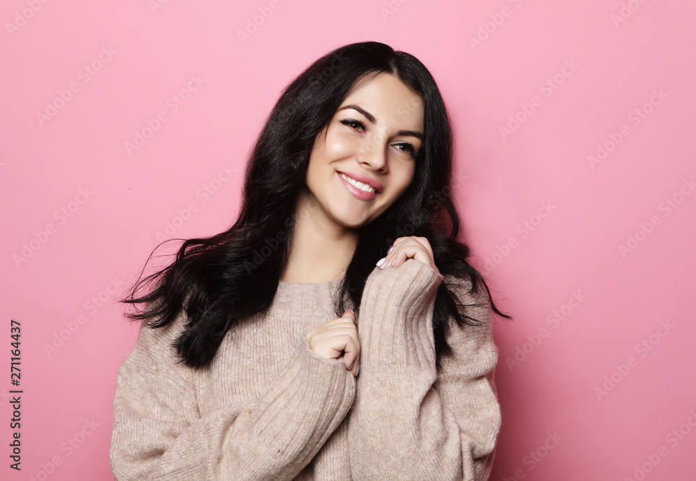 young positive female with cheerful expression, dressed in casual clothes over pink background. Lifestyle concept young positive female with cheerful expression, dressed in casual clothes over pink background. Lifestyle concept