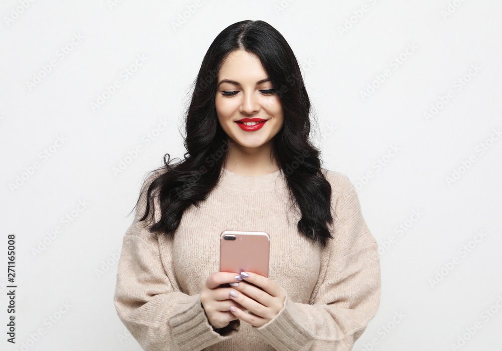 Fashion curvy brunette girl taking photo makes self portrait on smartphone Fashion curvy brunette girl taking photo makes self portrait on smartphone