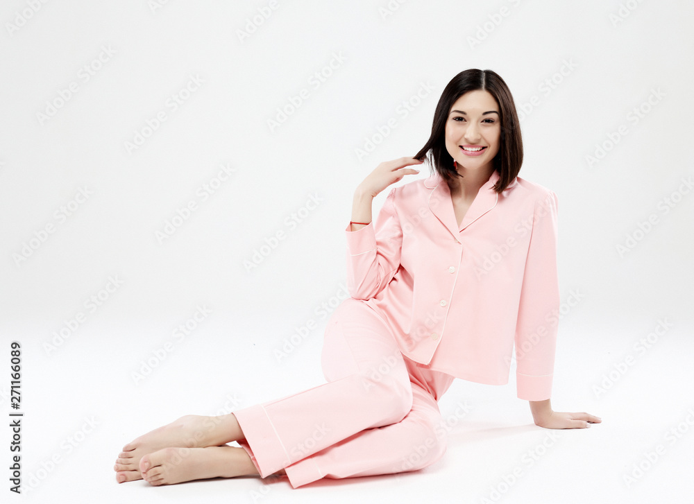 beautiful woman dressed in pajamas sitting on the floor beautiful woman dressed in pajamas sitting on the floor
